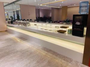 a long counter in a store with a display case at Lavande Hotel Changchun Gaoxin Jilin University in Changchun