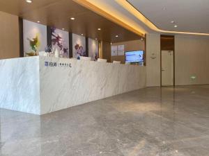 a lobby with a reception counter in a building at Lavande Hotel Changchun Gaoxin Jilin University in Changchun