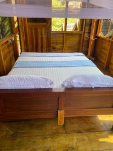 un par de camas en una habitación de madera en Surf Beach Hotel, en Arugam Bay