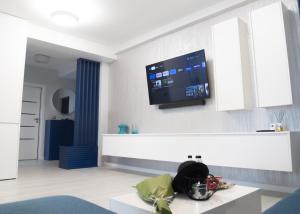a living room with a tv on the wall at Oltenia Studio Happy Residence Craiova in Craiova