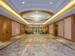 un grand hall avec un lustre et un plafond dans l'établissement Vienna Hotel Zhengzhou Only Henan Movie Town, à Zhongmou