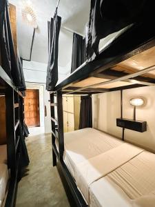 a bedroom with two bunk beds in a room at Dayon Hostel in Coron