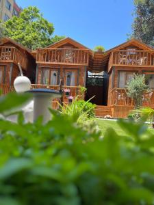 a wooden house with a garden in front of it at My Home Hotel Gulluk in Antalya