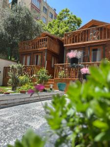 a wooden house with a balcony on a street at My Home Hotel Gulluk in Antalya