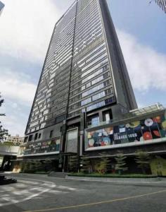 a tall building with a lot of windows on it at Shenzhen Cloud Park Manhattan Hotel in Tiantangwei