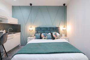 a bedroom with a large bed with a blue headboard at Apartments Blue Ivy in Zadar