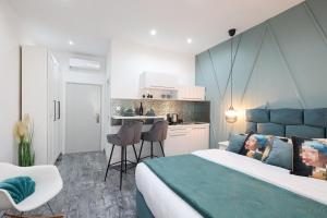 a bedroom with a large bed and a kitchen at Apartments Blue Ivy in Zadar