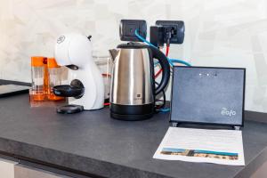 a kitchen counter with a coffee maker and a laptop at Casa Vacanza al Vecchio Ponte 