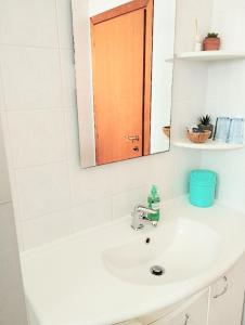 a bathroom sink with a mirror and a sink at Private room and bathroom close to Piazzale Roma in Venice Mestre in Mestre