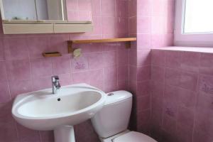 a pink bathroom with a sink and a toilet at Appartement au centre de TREBEURDEN et à 500m de la plage - Ref 665 in Trébeurden +12 photos