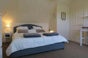 a bedroom with a large bed with two pillows on it at Maison de charme à 600m de la mer avec WIFI à PLEUMEUR - BODOU REF-648 in Pleumeur-Bodou