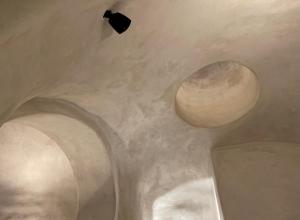 a room with two domes on the ceiling at Aethra Cave Suites in Pyrgos