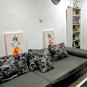 シブにあるCozy home in Sibu Near Daescoのリビングルーム(枕付きのソファ付)