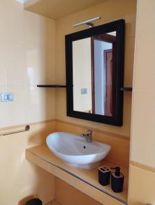 La salle de bains est pourvue d'un lavabo et d'un miroir. dans l'établissement Il Sole Dentro Holiday Home, à Pellezzano