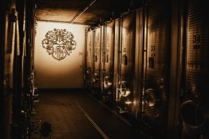 a hallway with lockers and a wall with a crest at Weingut Hans Bausch in Hattenheim