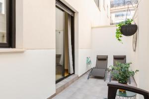 a balcony with a chair and a window at Malagaflat City Center in Málaga