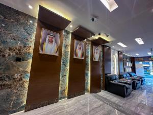 a waiting room with portraits of priests on the walls at GOLD SKY AVENUE HOTEL in Dubai