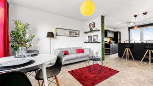 a living room with a couch and a table at Homey Savignat Aux portes de Paris in Créteil