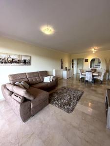 ein großes Wohnzimmer mit Couch und Tisch in der Unterkunft Beautiful apartment,3 min drive from the beach in Bahia de Casares