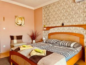 a bedroom with two beds with towels on them at Villa Lux in Hévíz