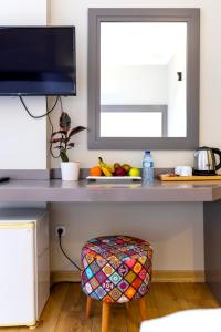 a table with a bowl of fruit and a mirror at Mene City Hotel in Antalya