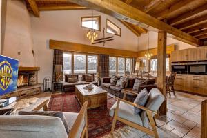 a living room with couches and a fireplace at Chalet Coeur in La Tzoumaz