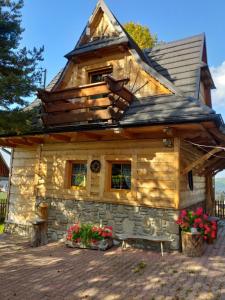 a log cabin with a bench in front of it at Góralski Domek z kominkiem - Highlander Wooden House in Murzasichle