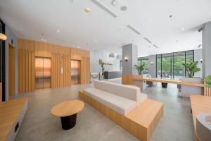 a living room with a couch and a table at Ando Hotel Batam in Nagoya