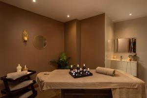 a room with a table with bottles and candles on it at Montcalm Royal London House, London City in London