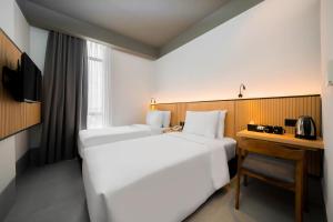 a hotel room with two beds and a desk at Ando Hotel Batam in Nagoya +7 photos