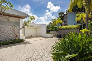 a driveway of a house with a garage at Private 3-Storey Pool Villa Atika 10, for 7, views of Patong Bay in Patong Beach