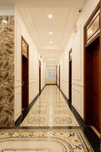 a corridor of a building with a tile floor at Mekong Gia Lai Hotel - Me Kong Pleiku in Pleiku