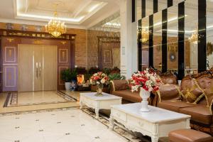 a lobby with couches and tables in a building at Mekong Gia Lai Hotel - Me Kong Pleiku in Pleiku