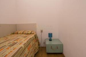 a bedroom with a bed and a blue lamp on a table at BOLINA e FIOCCO in Follonica