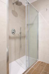 a shower with a glass door in a bathroom at Dimora Trecuori in Naples