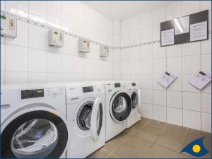 un lavadero con lavadora y secadora en Villa Vineta Whg 03, en Bansin