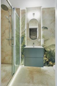 a bathroom with a sink and a mirror at Apartamenty Świnoujście -Seaside Garden 52 in Świnoujście