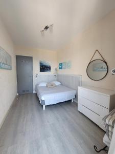 a bedroom with a bed and a dresser in it at Maison pieds dans l eau St Florent in Saint-Florent