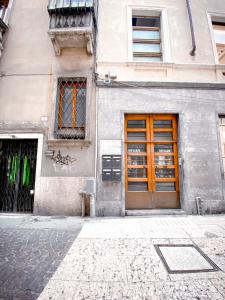 a building with a orange door on a street at Arena Sweet Home in Verona in Verona