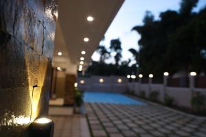 a hallway with lights on the side of a building at Twin Cottages in Thekkady