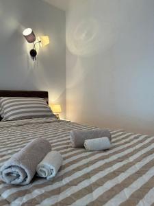 a bed with two towels on top of it at Kosancic No.1 in Belgrade