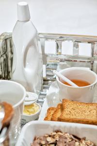 a tray of food with bread and a bottle at Sivota Diamond Spa Resort in Syvota