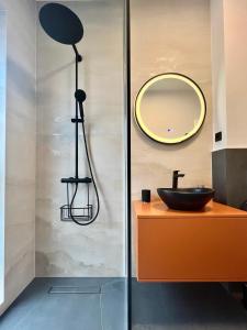 a bathroom with a sink and a mirror at Rhodium Apartment in Cluj-Napoca