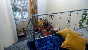 a bedroom with a bed with a metal head board at Двухуровневая квартира студия - Duplex studio apartment in Dushanbe