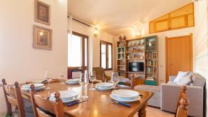 a dining room with a wooden table and chairs at Sardinianworld - La Casa Delle Rose in Santa Caterina