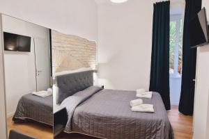 a bedroom with a large bed and a mirror at Oasi Guest House in Rome