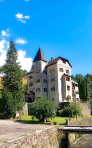 an old building with a tower and a bridge at Schloss Süßenstein in Hüttenberg