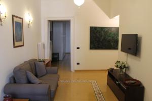 a living room with a couch and a tv at Residenza Santa Lucia in Naples