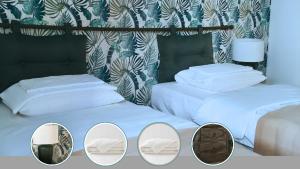 a group of three beds in a room at Villa Sérénité appartement au centre ville n 4 in Lourdes