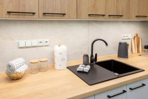 a kitchen counter with a sink and a candle at Apartmán Smraďavka in Buchlovice